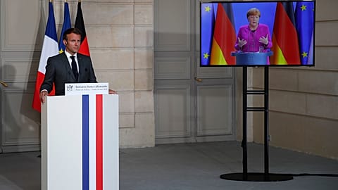 French President Emmanuel Macron listens to German Chancellor Angela Merkel during a joint video press conference Monday, May 18, 2020 in Paris. (AP/Francois Mori, Pool)