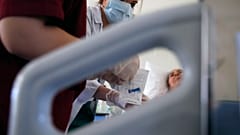 Medical student Eleni Fyta takes blood test from a patient at the Pathological Clinic of Sotiria Hospital