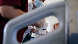 Medical student Eleni Fyta takes blood test from a patient at the Pathological Clinic of Sotiria Hospital