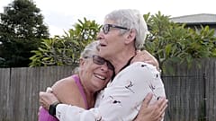 Christine Archer, right, and her sister Gail Baker cry as they are reunited in Bowraville, Australia 