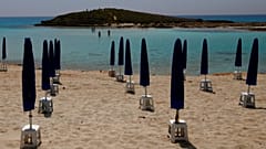 Rows of closed parasols on a nearly empty stretch of Nissi beach in Cyprus' seaside resort of Ayia Napa, a popular tourist destination, Wednesday, May 13 2020. 