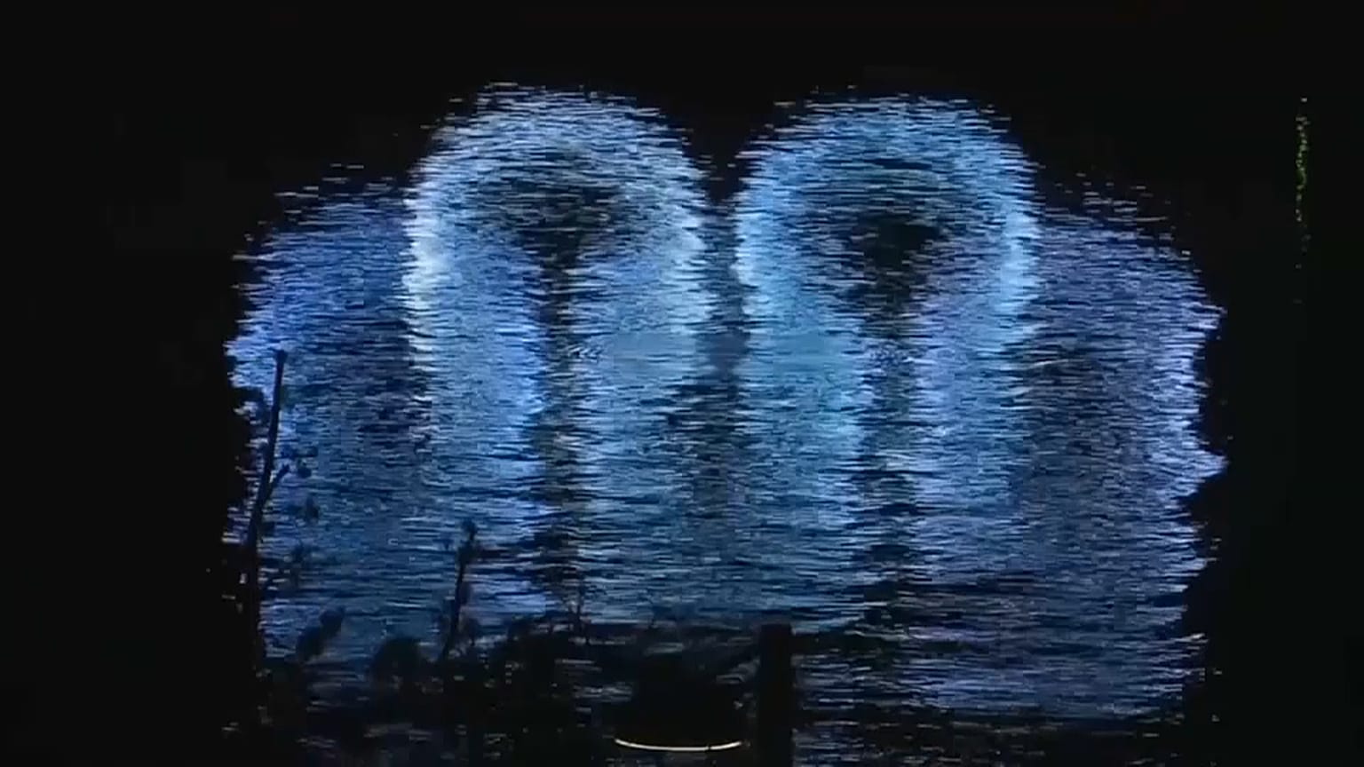 Olympics logo reflected on water