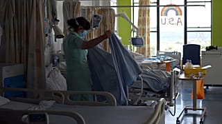 A health care assistant works on the Acute Stroke Unit at the Royal Blackburn Teaching Hospital in Blackburn, north-west England on May 14, 2020