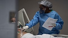 A nurse treats a COVID-19 patient at the intensive care in Brazil