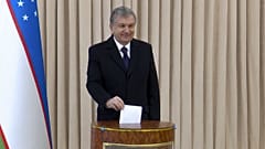 Uzbekistan's President Shavkat Mirziyoyev poses for a photo during the parliamentary elections at at a polling station in Tashkent, Uzbekistan, Sunday, Dec. 22, 2019