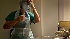 Nurse gets dressed in PPE, UK