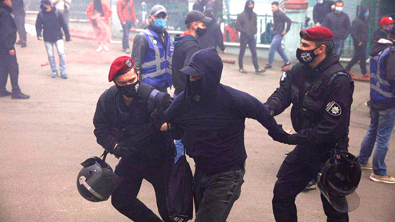 Ukrainian police officers detain a member of a far-right group