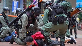 Riot police detain a protester during a demonstration against Beijing's national security legislation in Causeway Bay in Hong Kong