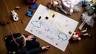 A girls makes a drawing reading "Everything is going to be alright", as part of school homeworks