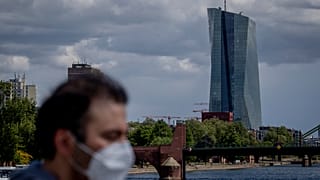 Man with mask passing by ECB Building