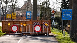 A container and barriers block a road on the Netherlands border with Belgium on March 23, 2020.