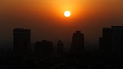 The sun rises amid smog during the dry season in Mexico City