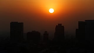 The sun rises amid smog during the dry season in Mexico City