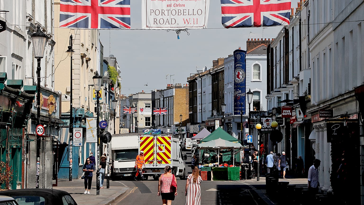 People walk along Portobello Road Market in London, Wednesday, May 27, 2020.