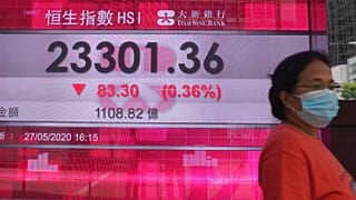 Hong Kong borsa binasının önünden geçen maskeli bir kadın
