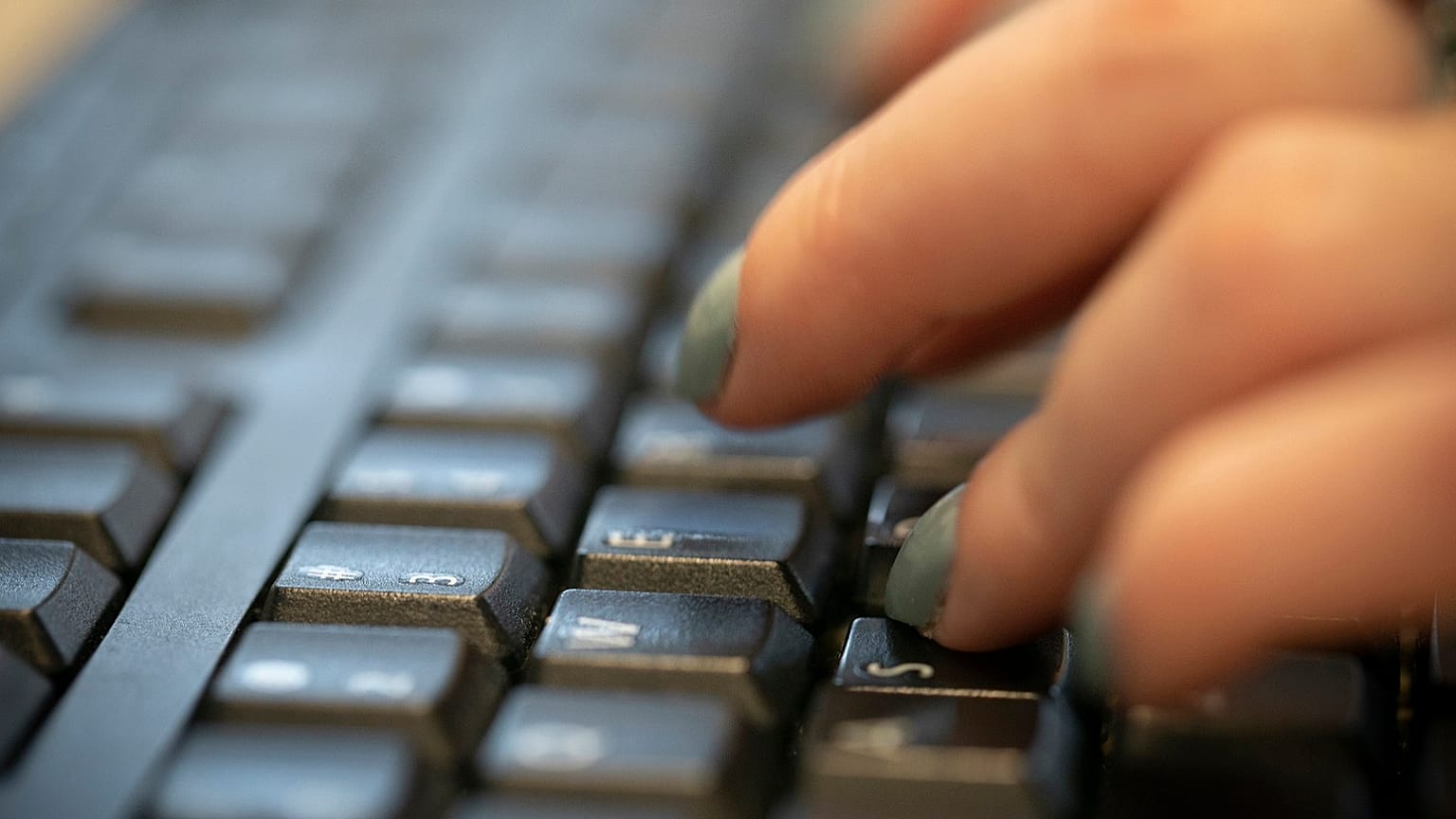 A woman types on a keyboard in New York