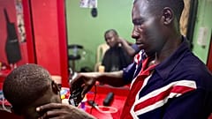 James, 30, has been helped to reintegrate into life in Nigeria after returning home from Libya. The IOM helped him to open a barbershop in Benin City, Edo State, Nigeria.