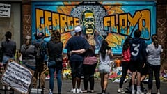 Visitors make silent visits to organic memorial featuring a mural of George Floyd, near the spot where he died while in police custody.