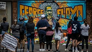 Visitors make silent visits to organic memorial featuring a mural of George Floyd, near the spot where he died while in police custody.