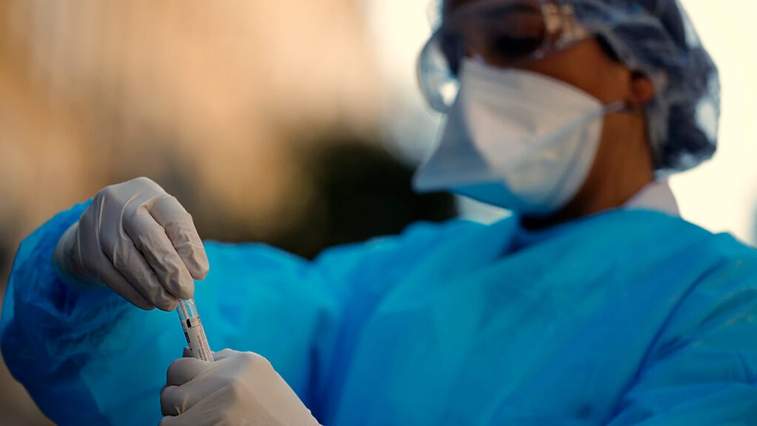 Biologist doctor prepares to swab a woman with covid-19 symptoms as she stays in her car Neuilly-sur-Seine, near Paris, Monday, March 23, 2020