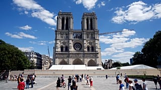 People walk on the forecourt of Notre Dame's Cathedral, in Paris, Sunday, May 31, 2020