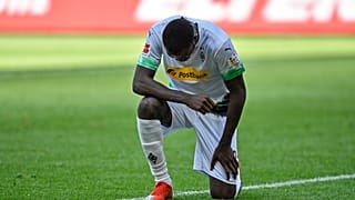Moenchengladbach's Marcus Thuram taking the knee after scoring his side's second goal during the Bundesliga soccer match between Borussia Moenchengladbach and Union Berlin.