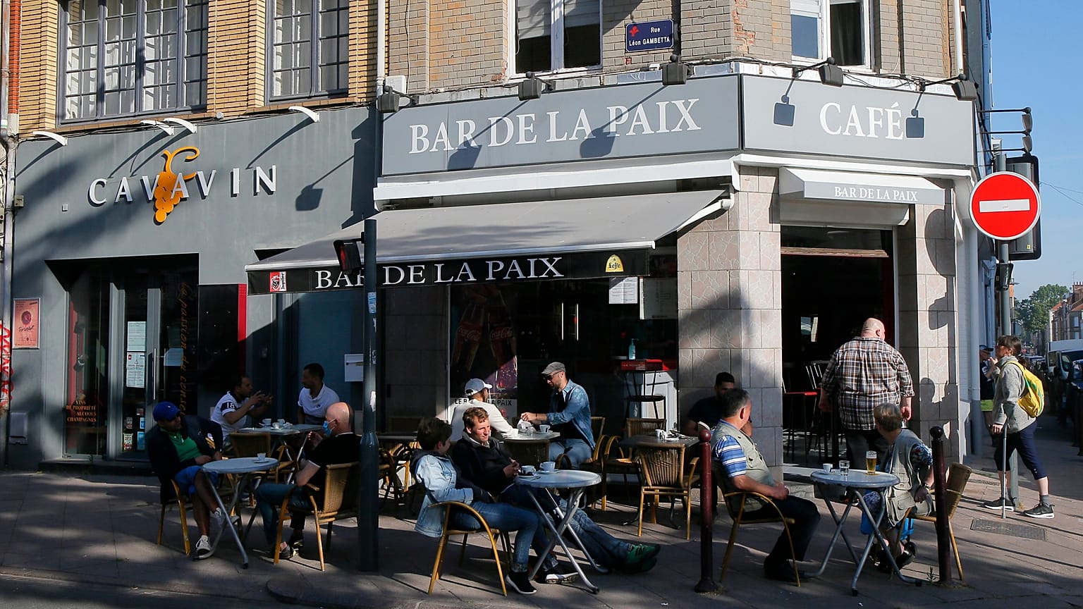 People enjoy sitting at a cafe terace in Lille