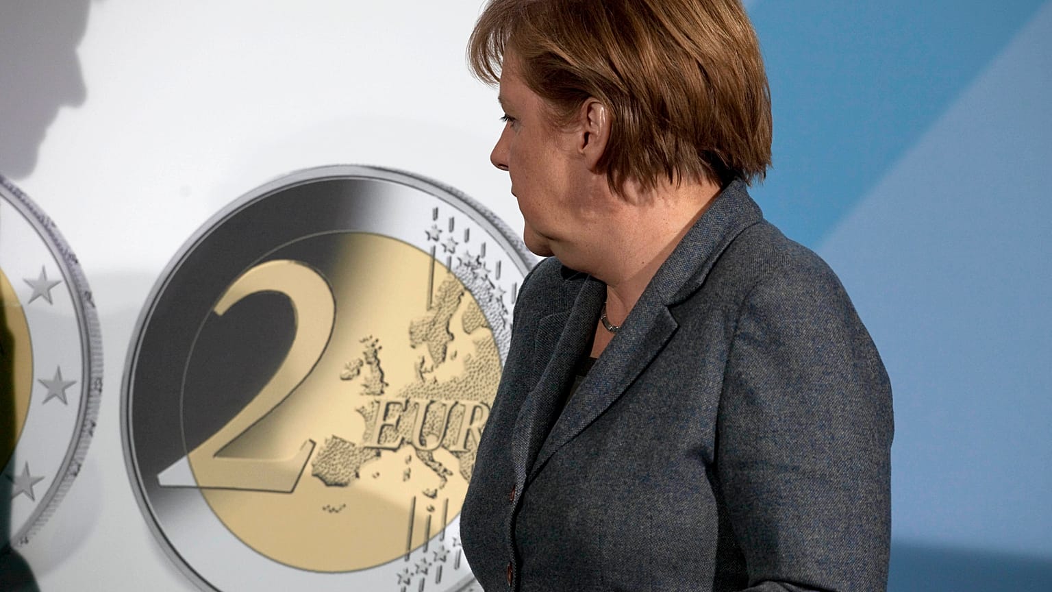 German Chancellor Angela Merkel turns to a panel showing a two Euro coin during the presentation of a special edition of the coin at the chancellery in Berlin, Germany, Thursd