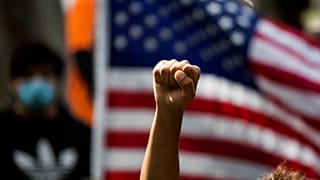 A demonstrator rises his fist during a protest over the death of George Floyd in Minneapolis,