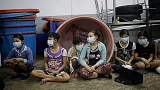 Children and teenagers to be registered by officials during a raid on a shrimp shed in Thailand.