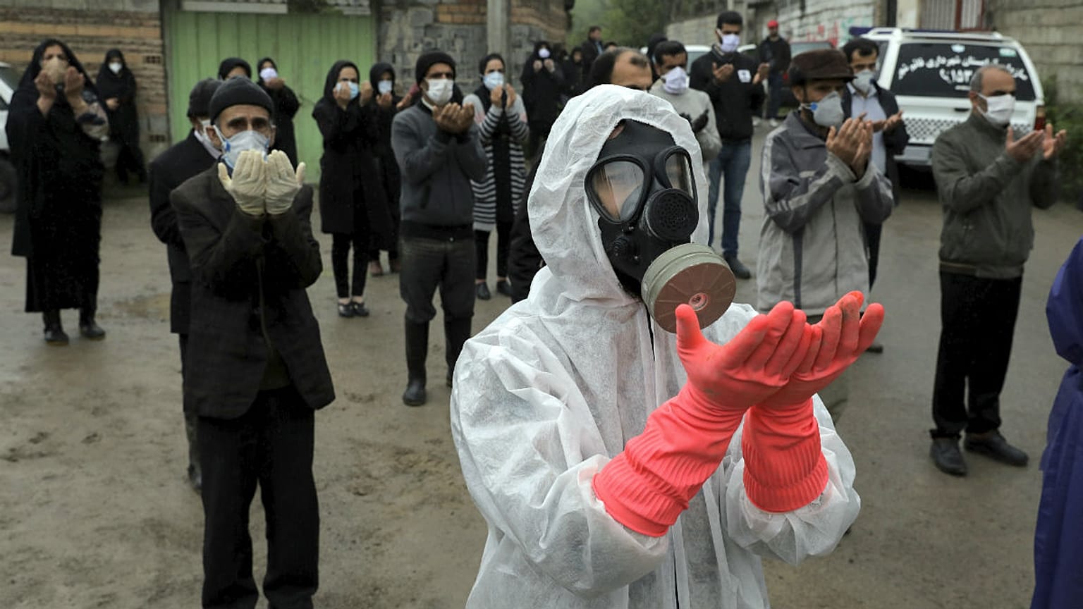 Mourners wearing protective clothing, face masks and gloves, city of Babol, in north of Iran