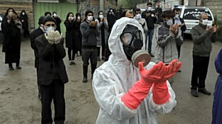 Mourners wearing protective clothing, face masks and gloves, city of Babol, in north of Iran