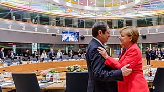 German Chancellor Angela Merkel, right, speaks with Cypriot President Nicos Anastasiades