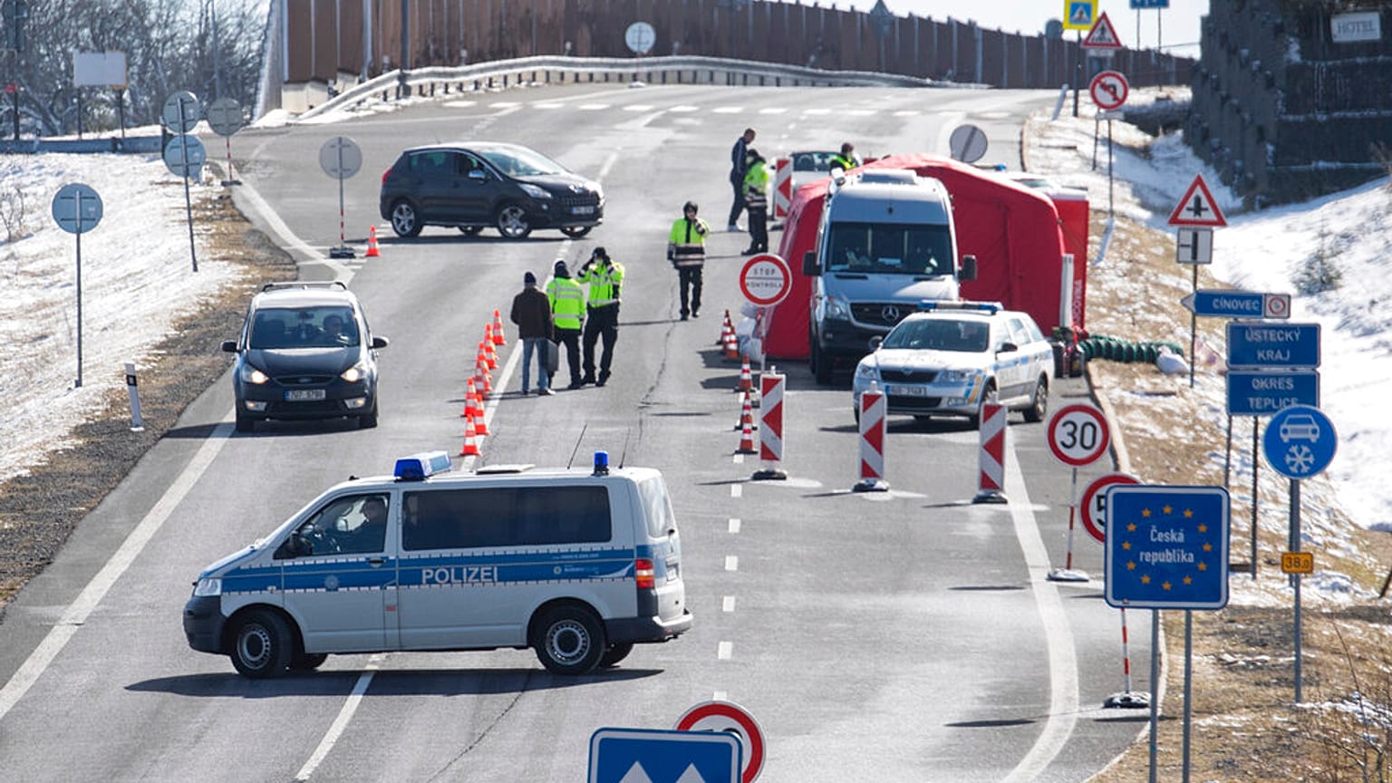 Czech policemen are standing on a street at the Czech border for entry control near Zinnwald, Germany.
