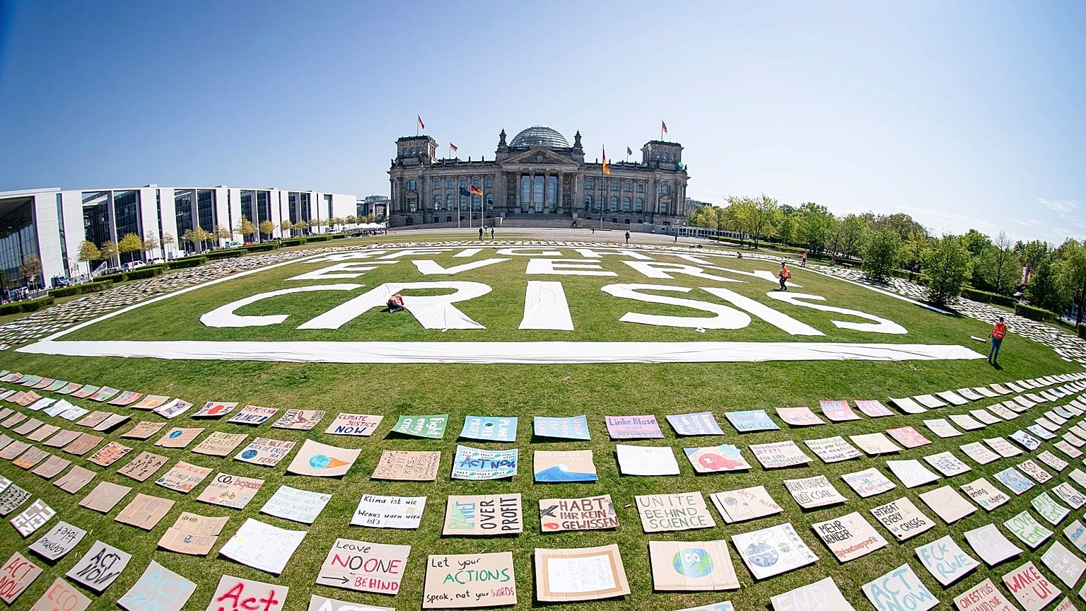 Activists of the Fridays for Future movement place protest posters for climate protection in front the German parliament in Berlin