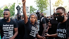 Assa Traore, sister of Adama Traore, raises her fist during a demonstration in Paris.