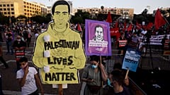 Protesters attenda rally against Israel plans to annex parts of the West Bank, in Tel Aviv, Israel, Saturday, June 6, 2020. 