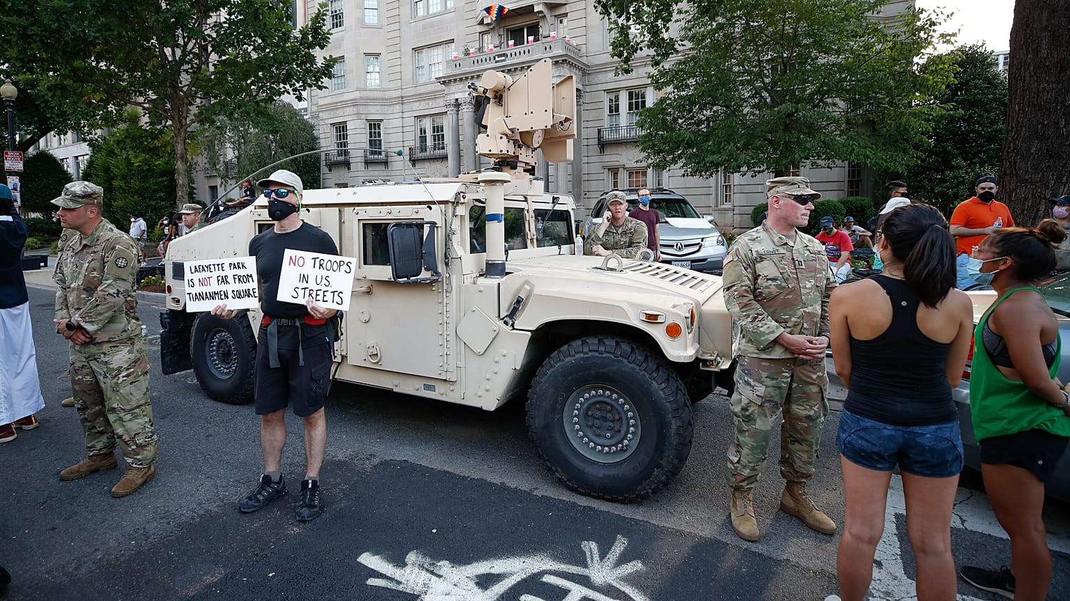 Demonstrators talk to National Guard soldiers as they protest Saturday, June 6, 2020, near the White House in Washington, over the death of George Floyd.