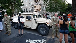 Demonstrators talk to National Guard soldiers as they protest Saturday, June 6, 2020, near the White House in Washington, over the death of George Floyd.