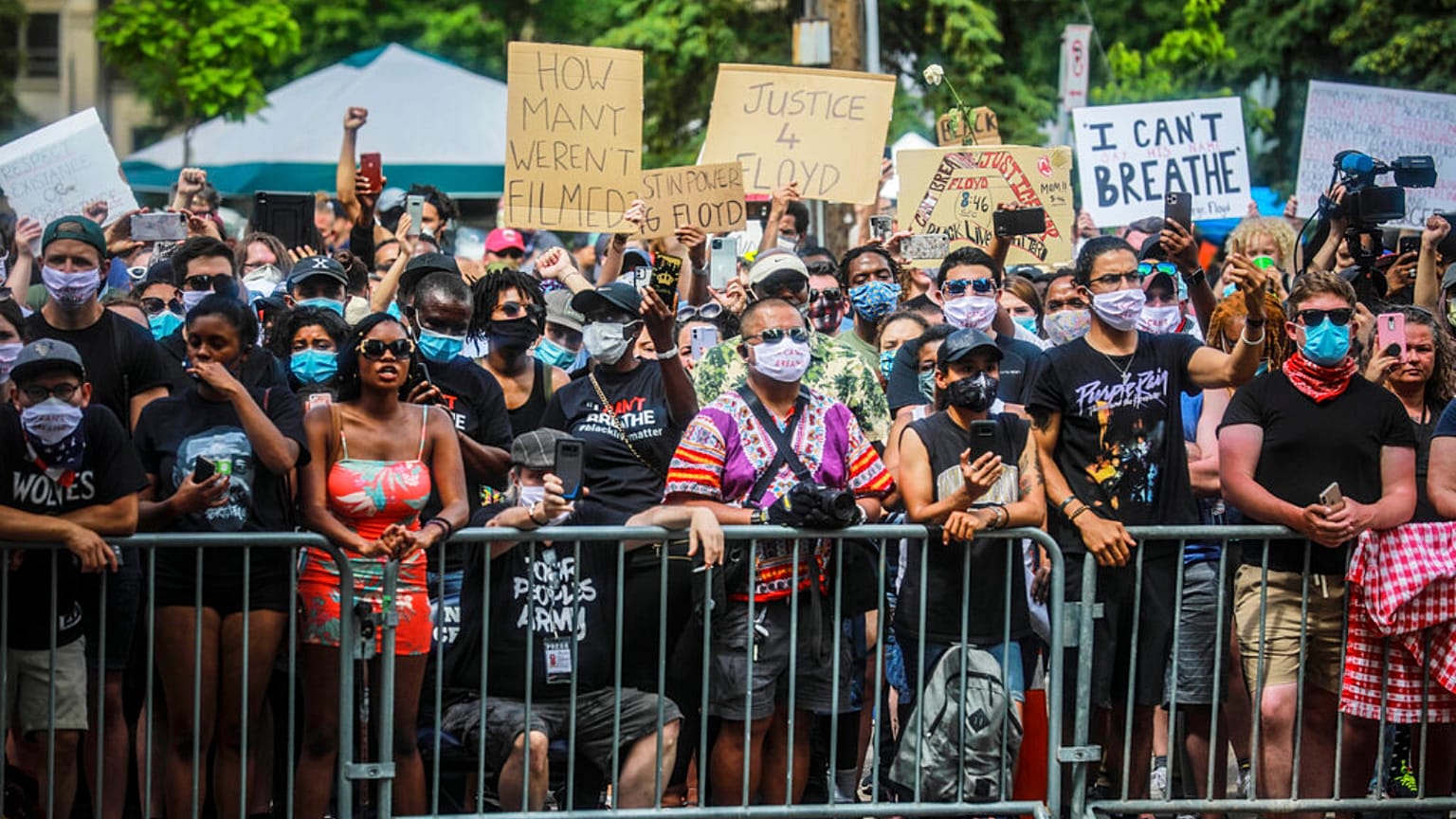 A crowd chants "Say his name" as George Floyd's casket is wheeled to a hearse after a memorial service at North Central University, Thursday, June 4, 2020, in Minneapolis.