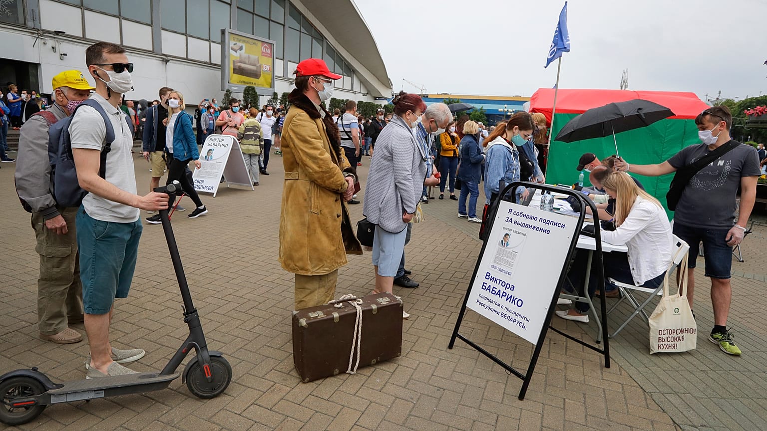 People, wearing face masks to protect against coronavirus, give their signatures in support of potential presidential candidates in the presidential elections in Minsk