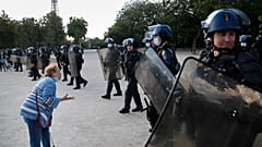 An elderly woman haggles French riot police during a demonstration in Paris, France, Saturday, June 6, 2020, to protest against the recent killing of George Floyd.