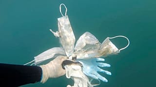 Esta foto tomada el 21 de mayo de 2020 muestra guantes de plástico y máscaras faciales y otros desechos frente a Antibes, en el sur de Francia.