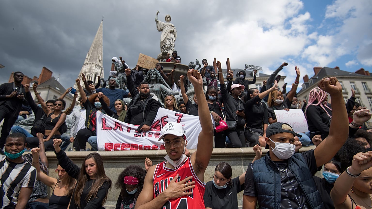 People chant slogans and hold placards, as they demonstrate in Nantes during a 'Black Lives Matter' worldwide protests against racism and police brutality. France