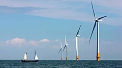 A vessel sails towards a wind farm off the coast of Whitstable on the north Kent coast in England.