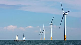 A vessel sails towards a wind farm off the coast of Whitstable on the north Kent coast in England.