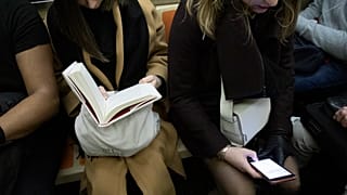 Woman looking at mobile phone on a New York subway