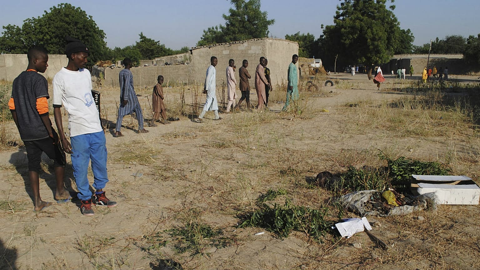 People gathered at the site of a suicide attack in Maiduguri, Nigeria, Thursday, Nov. 16, 2017.