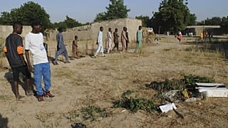 People gathered at the site of a suicide attack in Maiduguri, Nigeria, Thursday, Nov. 16, 2017.