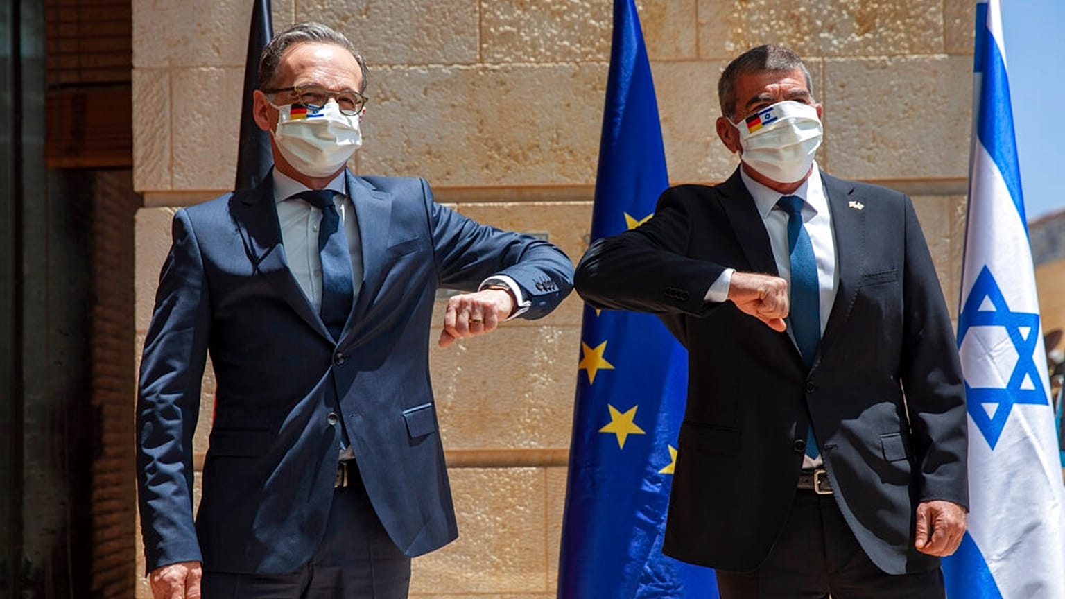 Israeli Foreign Minister Gabi Ashkenazi, right, welcomes his German counterpart Heiko Maas with an elbow bump prior to their meeting in Jerusalem, Wednesday, June 10, 2020